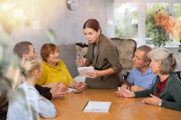 istock Young female teacher explaining subject to mature students 1473181752