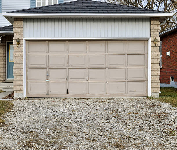 istock Old garage door with a gravel driveway 147318526
