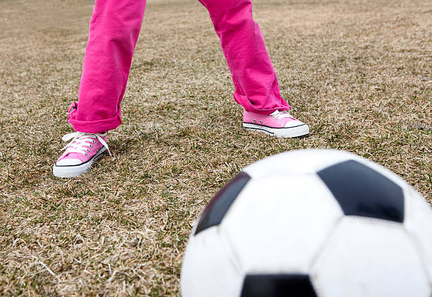 istock girl playing soccer 147318571