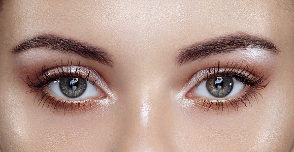 Female eye with extreme long false eyelashes. Eyelash extensions. Makeup, cosmetics, Beauty. Close up, macro