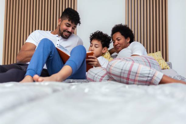 istock Family reading a book in bed 1473186678