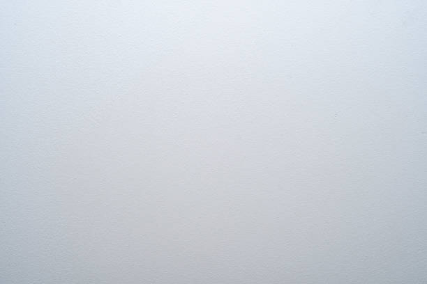 istock Background with light walls covered with white paint. Selective focus on part of the wall. White geometric backdrop with sharp corners. 1473188671