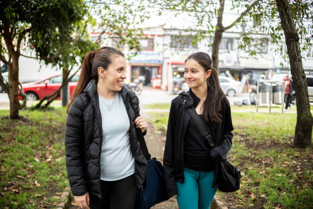 istock Mature mother talking with her daughter while walking at public park 1473191506