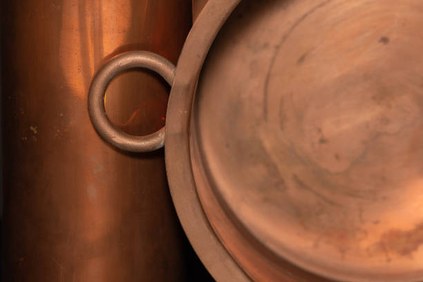 The warm shine of copper metal in utilitarian pots.