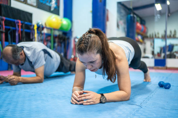 istock Mature woman on plank position at gym 1473193718