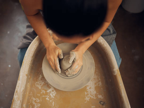 istock Hands, pottery and clay mold in the workshop for art, design or creative small business startup. Hand of employee artist in craft, molding or shaping with ceramics for creativity at the workplace 1473194719