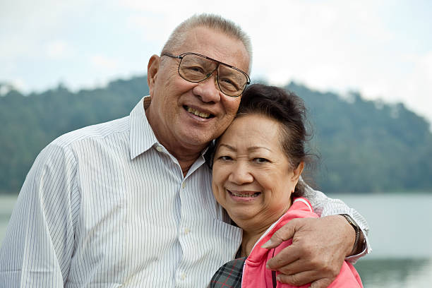 istock romantic asian senior couple on the lake 147319501