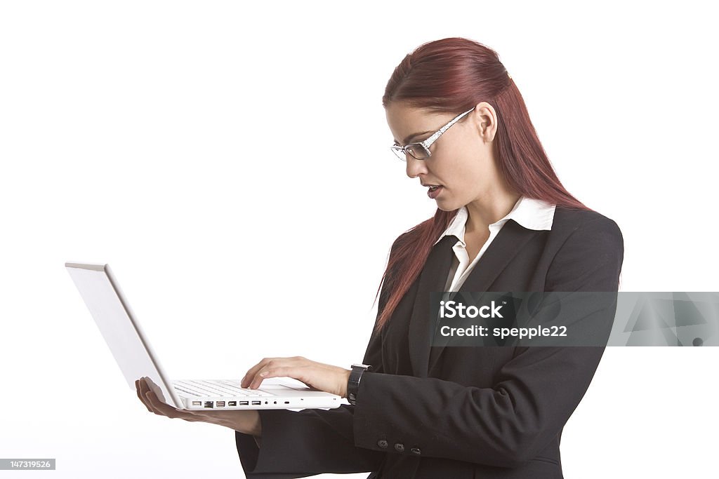 Executive at work Business woman standing up working on a laptop computer Adult Stock Photo