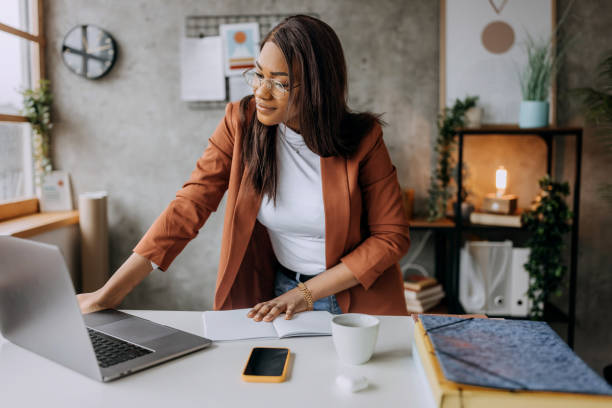 istock Beautiful well dressed businesswoman using laptop while working at home office 1473195602