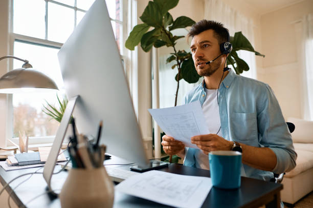 istock Businessman talking during online video meeting while working at home office. 1473198196