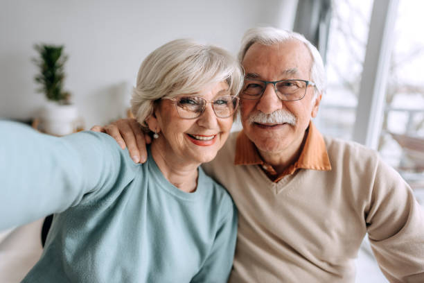 istock Senior couple selfie at home 1473198311