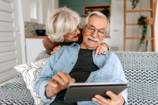 istock Happy senior couple using digital tablet together at home 1473198666