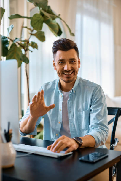 istock Happy entrepreneur working on desktop PC at home and looking at camera. 1473199465