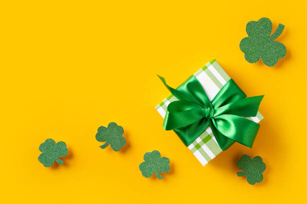 istock Saint Patrick day concept flat lay with green gift box close up on yellow background, 1473199663