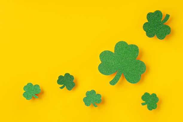 istock Saint Patrick day concept flat lay with green clover leaf close up on yellow background, 1473199686