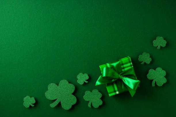 istock Saint Patrick day concept flat lay with green gift box close up on yellow background, 1473199702