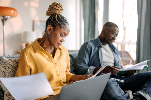 Couple working together at home, going over paperwork