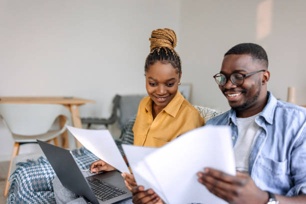 istock Couple working together at home, going over paperwork 1473199778