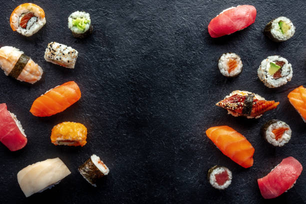 istock Sushi frame, overhead flat lay shot. Rolls, maki, nigiri on a black background 1473199842