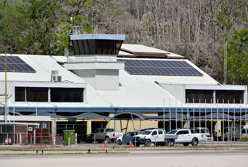 Yaren, Nauru: air traffic control tower and passenger terminal at the Republic of Nauru International Airport, the only airport in the country (there are no domestic flights). The airport was built in 1943 by the Japanese administration of the island. Forest and limestone pinnacles in the background.