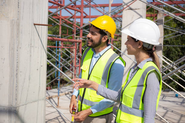 istock Engineer young man and woman using tape measure for check and examining length of structure at construction site, architect or contractor inspection and improvement infrastructure, industrial concept. 1473202242
