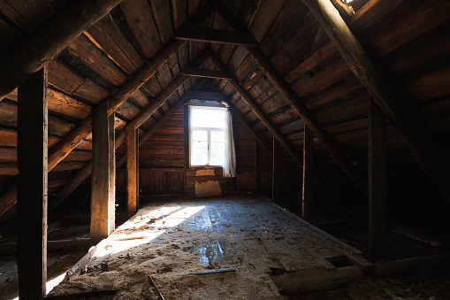 Abstract grunge wooden interior, perspective view of an abandoned attic room with glowing window