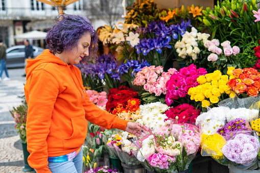 Portrait Of A Florist Placing Flowers In Her Flower Shop. Small Business.