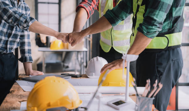 istock Team architects workers  join hands to join forces to join forces to work for the industry for success. Teamwork and professional colleagues : Workers' hands, teamwork concept. 1473204133