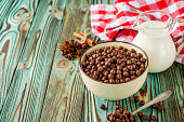 sweet crunchy chocolate children's breakfast chocolate balls on a wooden rustic background