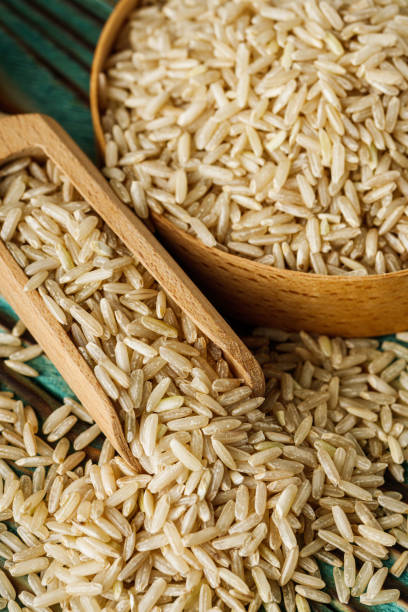 istock raw unpolished rice on a wooden rustic background 1473205007