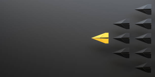 istock Leadership concept, yellow leader plane leading black planes, on black background with empty copy space on left side 1473205957