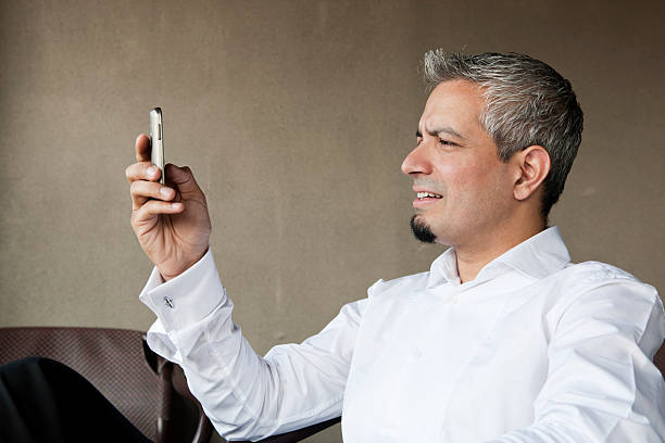 portrait of a young businessman using his mobile phone stock photo