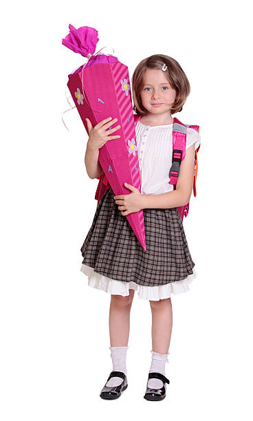 Little girl with school cone isolated on white