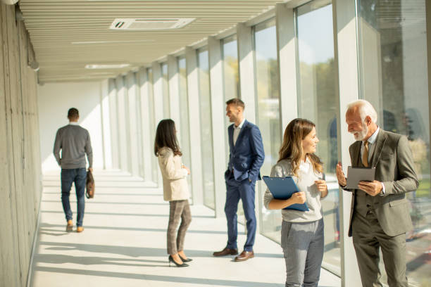 istock Modern business people using digital tablet in the office corridor 1473208235
