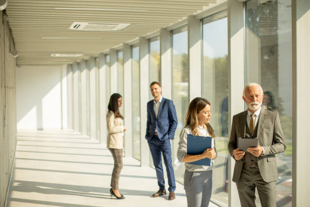 istock Modern business people using digital tablet in the office corridor 1473208462