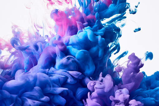 Splash of flowing blue and pink paint abstract background