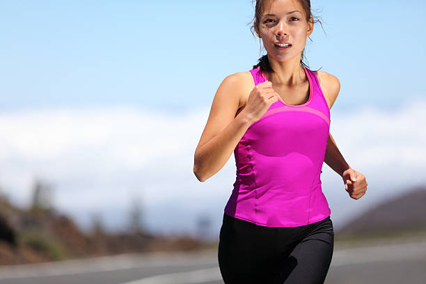istock Young woman runner in pink shirt training for marathon 147321109
