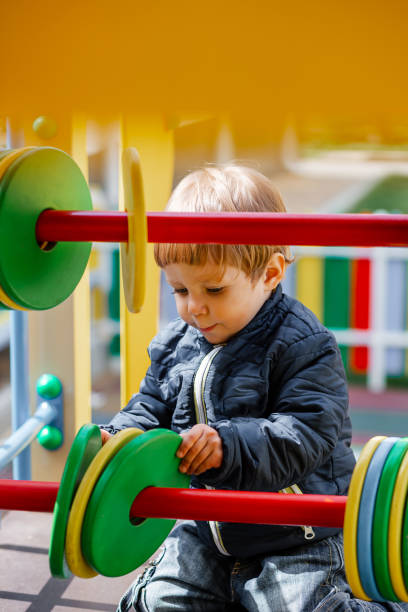 istock Little boy playing on the playground. Summer vacation 1473211794