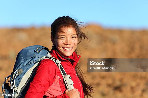 Young Woman With A Backpack Smiling At Camera Stock Photo - Download Image Now - Hiking, Outdoors, One Woman Only