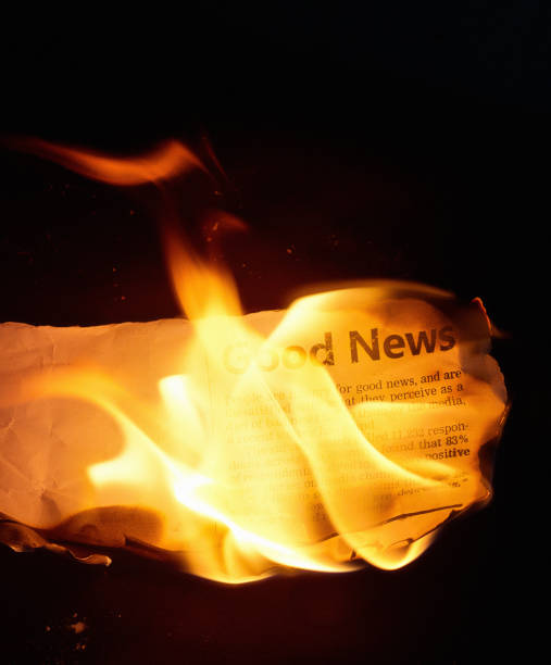 istock Newspaper cutting goes up in flames 1473212797