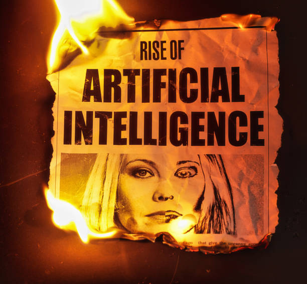 Burning simulated newspaper clipping about the rise of artificial intelligence. The text was written from scratch by the photographer, who also did the design and shot the photograph, which is properly model-released, so this image is free of third-party copyright and may be used without restrictions.