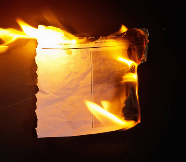 Burning newspaper clipping, with blank space for copy