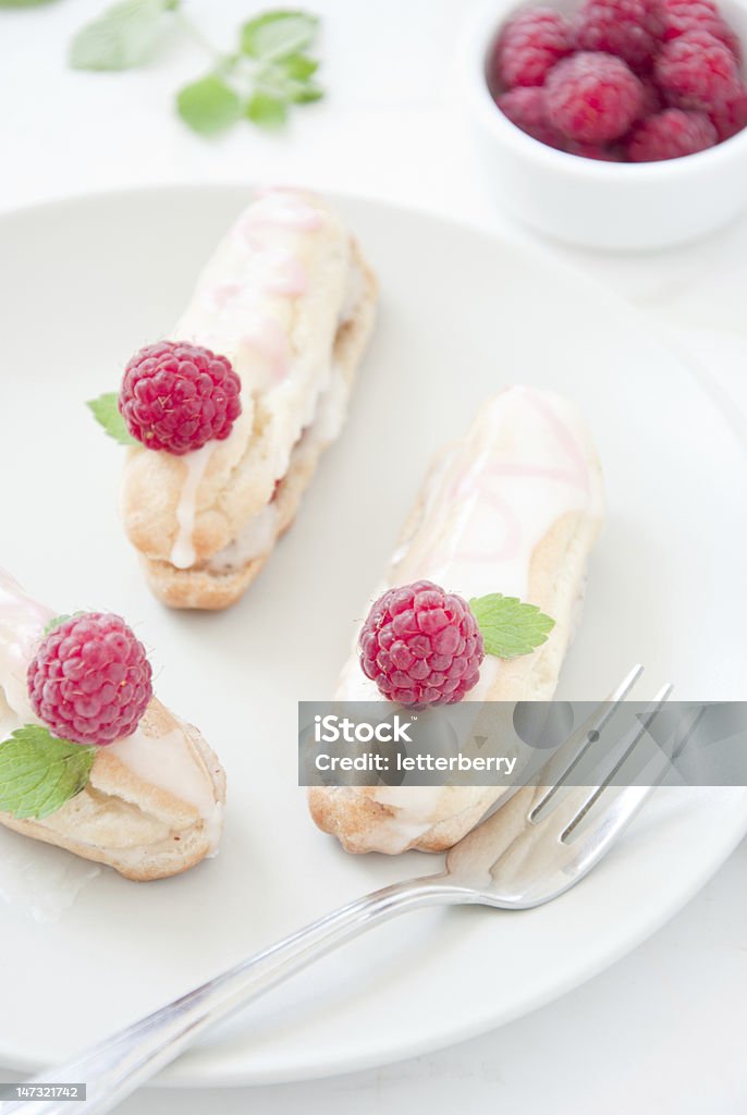 Eclairs with raspberries Baking Stock Photo