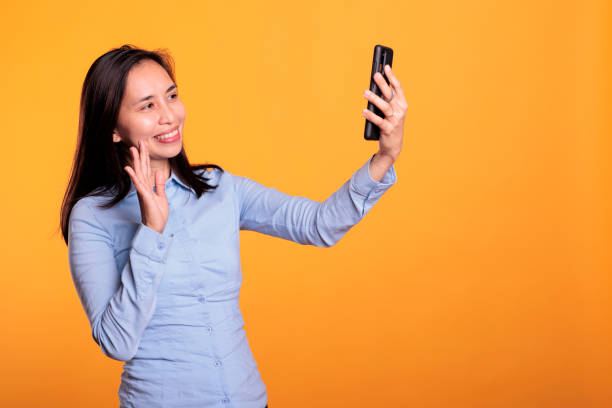 istock Joyful asian woman talking with remote friend 1473220432