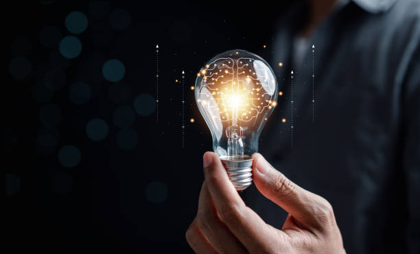 istock Hand man holding illuminated lightbulb, idea, innovation and inspiration with glowing virtual brain, smart intelligent creativity with bulbs, Motivation and innovation concept. 1473221254