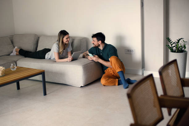 istock Couple using their phones at home 1473222069