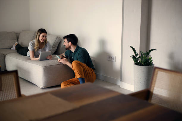 istock Couple using their phones at home 1473222130