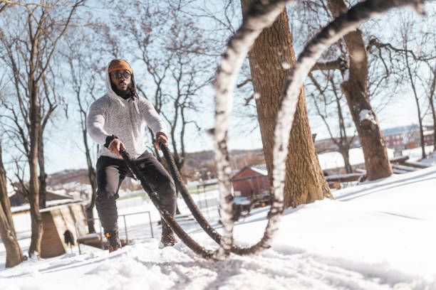 istock Man using battle ropes at the outdoor gym 1473222293