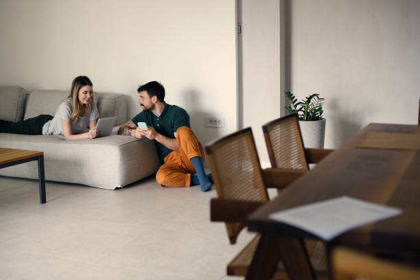 istock Couple using their phones at home 1473222329
