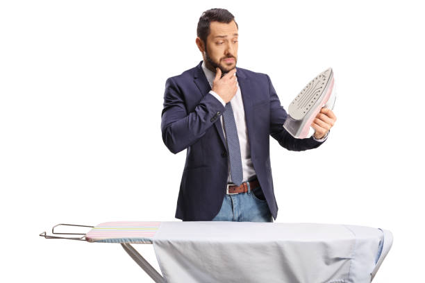 istock Confused mature man holding an iron 1473224543
